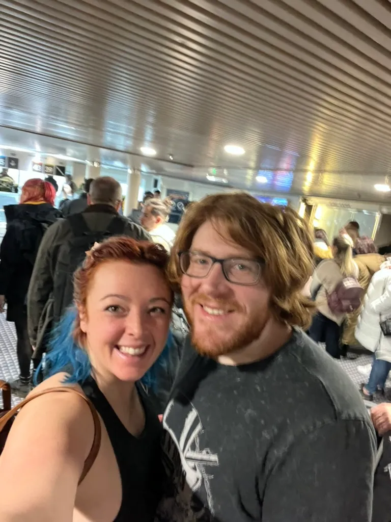 The two of us squeezed into the crowd waiting to get off the ship, other passengers with coats and bags packed in behind us.