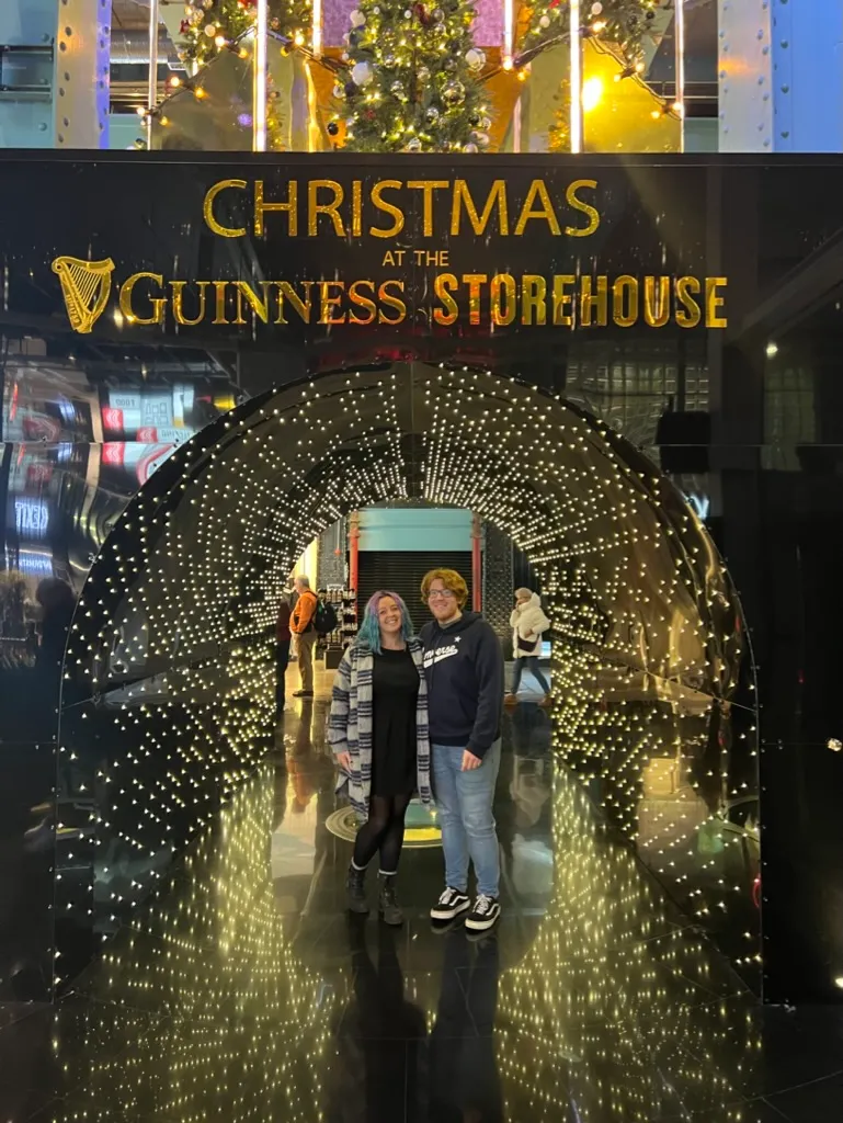 The two of us in the Christmas at the Guinness Storehouse light tunnel, thousands of small warm lights forming an arch