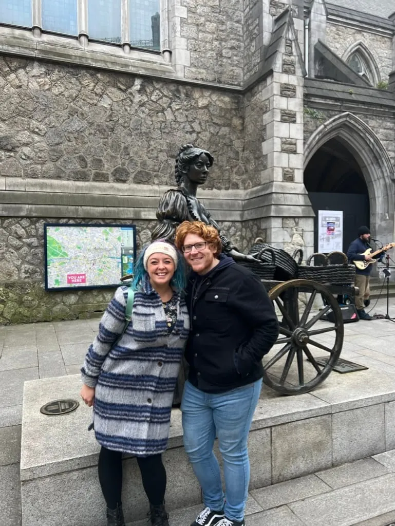 The two of us in front of the Molly Malone statue in Dublin, a busker playing behind us