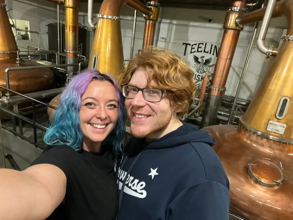 Copper pot stills in the Teeling distillery with the two of us in a selfie in front of them
