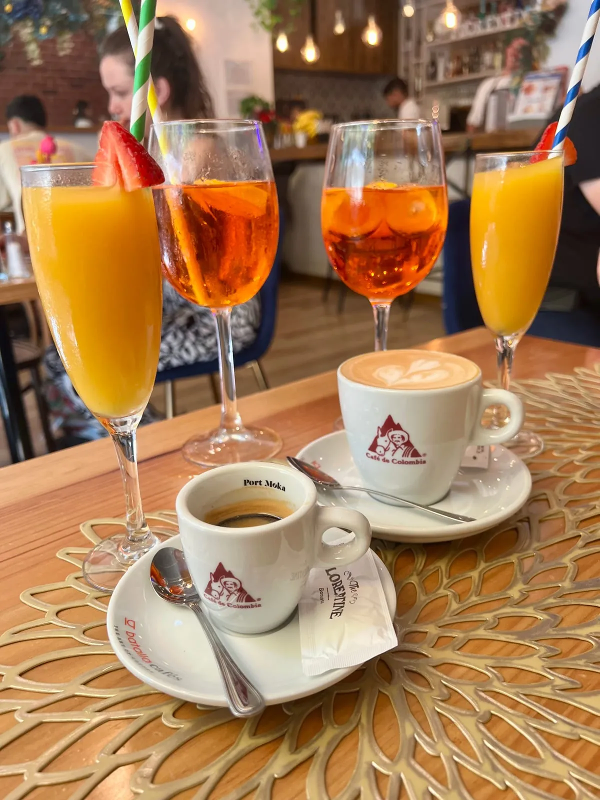 Two mimosas, two Aperol Spritzes, an espresso and a cappuccino on the table at The Florentine, Barcelona
